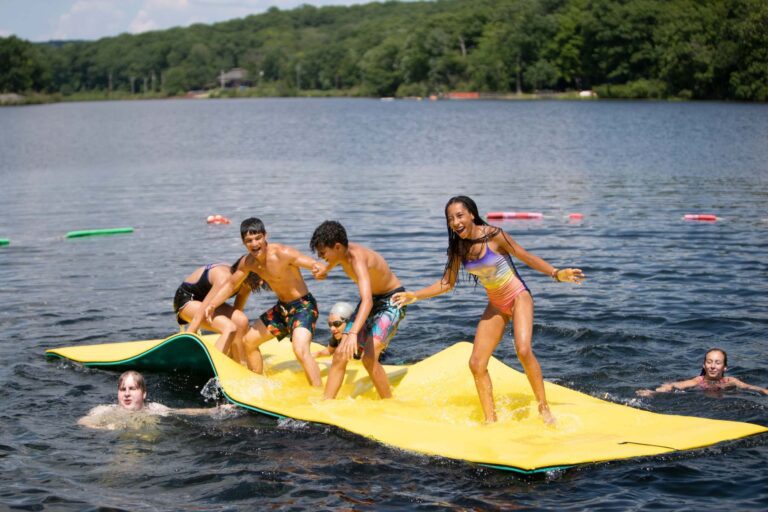 Campers playing on floating mat