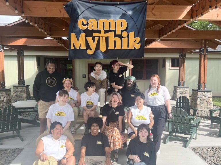 Group under camp banner