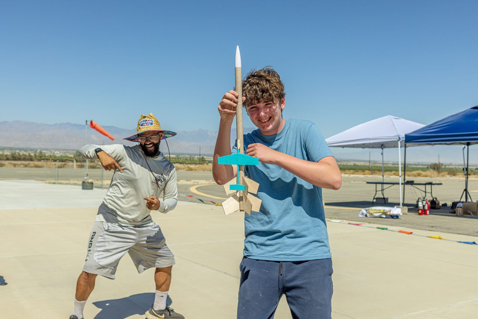 Camper holding model rocket.
