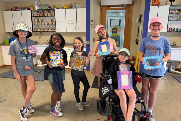 Girls showing off artwork
