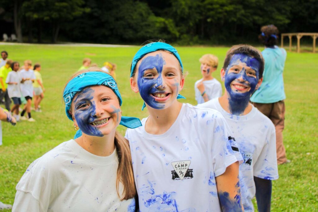 Campers wearing color war paint
