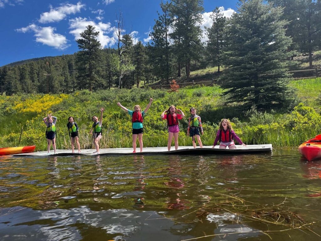 Campers playing on floating water mat