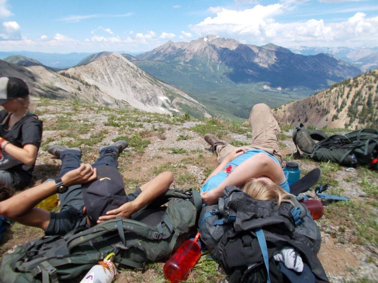 Campers relaxing on top of a mountain