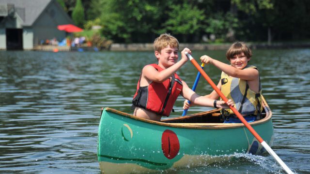 Two happy boys in a canoe