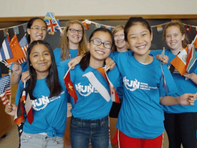 Debate campers holding various nation flags