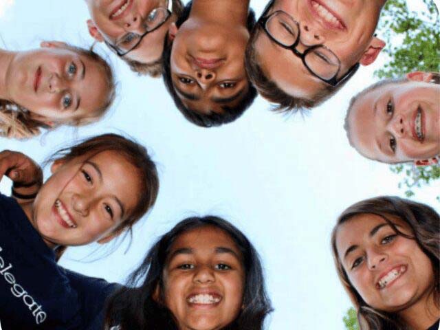 Campers forming a circle looking down at the camera