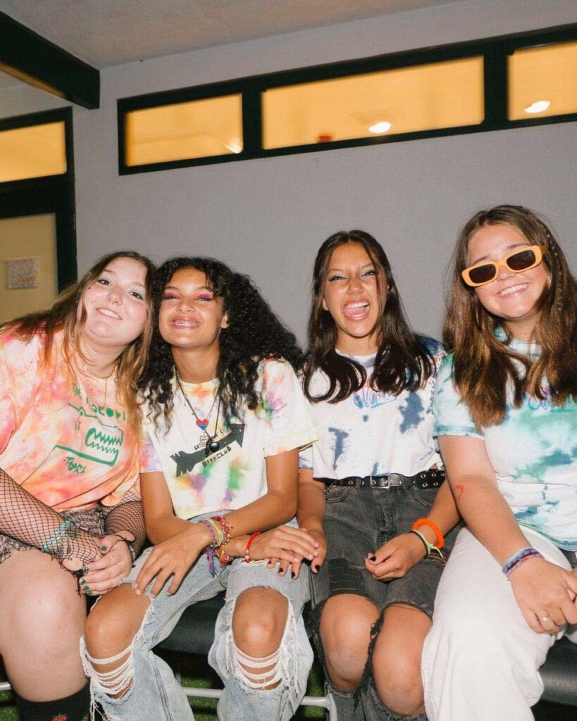 Joyful teen girls smiling at the camera