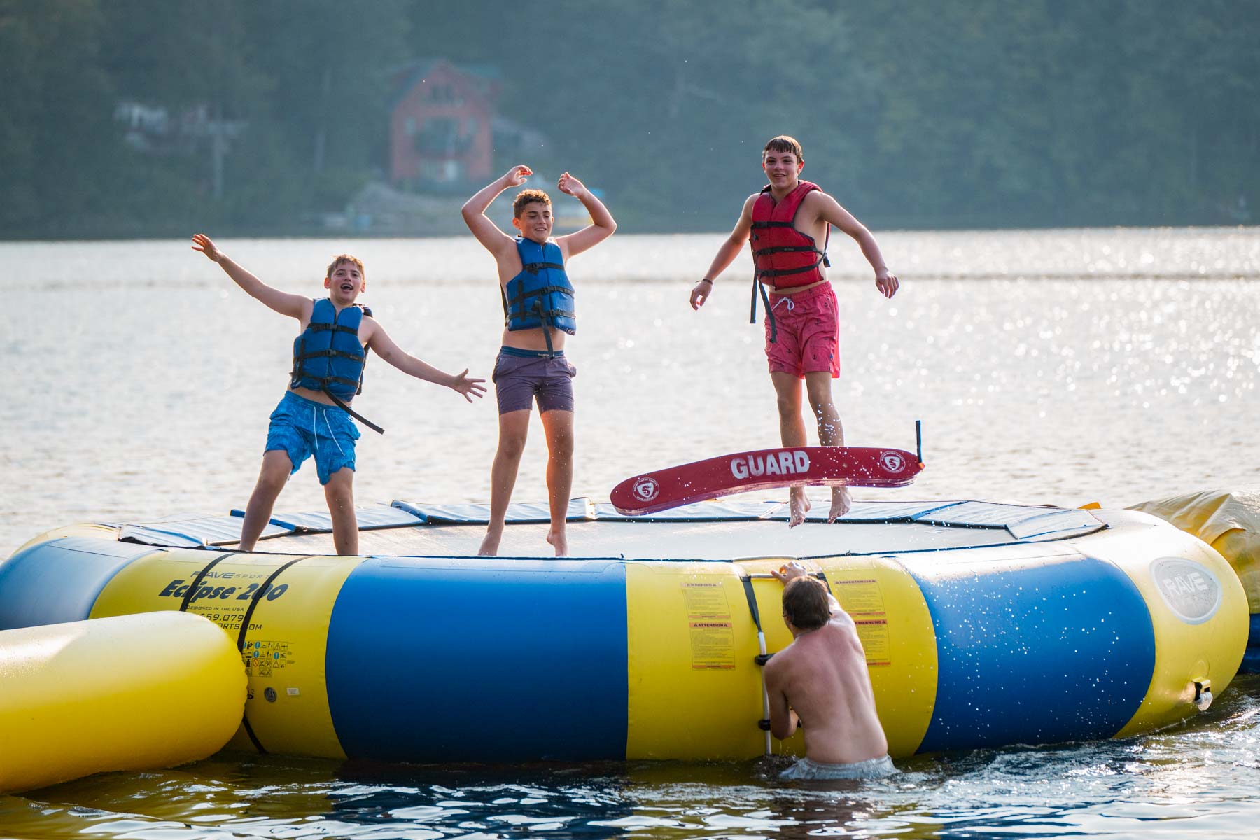 Boys jumping on a water trampoline