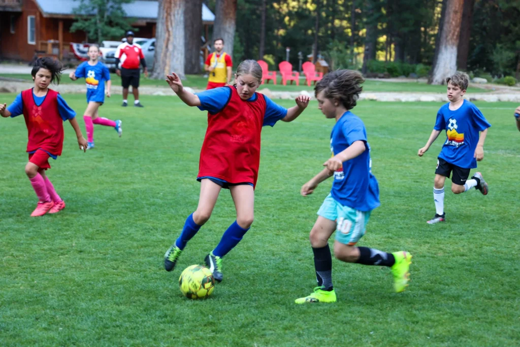 Campers playing soccer outdoors
